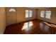 Living room with hardwood flooring, with natural light and white door at 148 Baptist Church Rd, Henderson, NC 27537