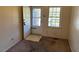Cozy room featuring a white door, neutral walls, and a window at 148 Baptist Church Rd, Henderson, NC 27537