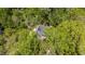 Overhead aerial shot of home surrounded by a dense forest of lush green trees at 149 Amber Rd, Timberlake, NC 27583