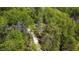 Aerial view showcasing a home nestled amongst a canopy of lush green trees at 149 Amber Rd, Timberlake, NC 27583