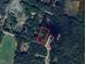 Aerial view highlighting the parcel surrounded by mature trees and lush greenery at 149 Amber Rd, Timberlake, NC 27583