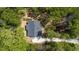 Aerial view of a home with a new roof surrounded by a lush, green landscape and mature trees at 149 Amber Rd, Timberlake, NC 27583
