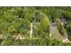 Aerial view showcasing a home nestled within a lush, green forest setting, emphasizing privacy at 149 Amber Rd, Timberlake, NC 27583