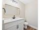 Elegant powder room featuring a modern vanity with sleek fixtures and a stylish gold-trimmed mirror at 149 Amber Rd, Timberlake, NC 27583