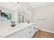 Bathroom featuring a dual sink vanity, a luxurious soaking tub, modern fixtures, and a separate glass-enclosed shower at 149 Amber Rd, Timberlake, NC 27583