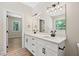 Modern bathroom has double sinks, white cabinets, quartz countertop, and black hardware at 149 Amber Rd, Timberlake, NC 27583