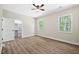 Bright, airy bedroom with wood-look floors, two windows, and a walk-in closet at 149 Amber Rd, Timberlake, NC 27583