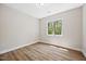 Bedroom featuring light-filled space with hardwood floors and a window providing beautiful views of the surrounding trees at 149 Amber Rd, Timberlake, NC 27583