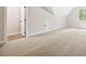 Bright and spacious bonus room with plush carpeting and natural light from window at 149 Amber Rd, Timberlake, NC 27583