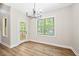 Bright dining room featuring hardwood floors, a modern chandelier, and a door leading to an outdoor deck at 149 Amber Rd, Timberlake, NC 27583