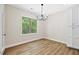 Dining room features hardwood floors, a modern light fixture, and natural lighting at 149 Amber Rd, Timberlake, NC 27583
