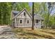 Charming home with gray siding, stone accents, and a welcoming front porch surrounded by mature trees at 149 Amber Rd, Timberlake, NC 27583