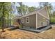 Side view of the exterior showcasing the wooden porch, and a driveway leading to the garage at 149 Amber Rd, Timberlake, NC 27583