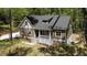 Inviting exterior view of home with covered porch, attractive siding, and beautifully landscaped yard surrounded by mature trees at 149 Amber Rd, Timberlake, NC 27583