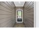 Inviting entryway featuring a classic front door with a glass pane, complemented by wood-like siding at 149 Amber Rd, Timberlake, NC 27583