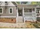 Inviting front entrance with stone accents, a covered porch, and fresh landscaping at 149 Amber Rd, Timberlake, NC 27583
