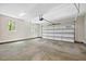 Clean, spacious garage with a modern door, windows, and ample room for parking and storage at 149 Amber Rd, Timberlake, NC 27583