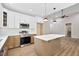 Open concept kitchen with a modern island, stainless steel appliances, and hardwood flooring at 149 Amber Rd, Timberlake, NC 27583