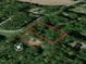Drone's-eye view showcasing the property lines amidst the trees and Amber Rd. , highlighting its secluded location at 149 Amber Rd, Timberlake, NC 27583