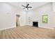 Bright living room featuring hardwood floors, fireplace, and large windows for natural light at 149 Amber Rd, Timberlake, NC 27583