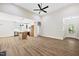 Open concept living room and kitchen area, featuring a ceiling fan and natural light from the entry door at 149 Amber Rd, Timberlake, NC 27583
