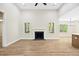 Bright living room featuring hardwood floors, fireplace, and large windows for natural light at 149 Amber Rd, Timberlake, NC 27583