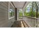 Cozy covered porch with gray wood and white railing, perfect for relaxing outdoors at 149 Amber Rd, Timberlake, NC 27583