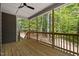 Outdoor porch with wooden floors and railings, providing a serene space to enjoy the surrounding trees and nature at 149 Amber Rd, Timberlake, NC 27583
