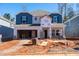 New two-story home with blue and gray siding and open garage under construction at 161 Klamath Dr, Garner, NC 27529