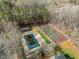 Aerial view of a pool and tennis courts nestled in a wooded community at 1613 Bulon Dr, Cary, NC 27518