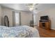 Comfortable bedroom with large windows, a ceiling fan, hardwood floors, and a floral patterned bedspread at 1613 Bulon Dr, Cary, NC 27518