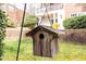 Charming wooden birdhouse hanging in a green backyard setting at 1613 Bulon Dr, Cary, NC 27518