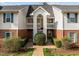 Exterior view of a townhouse complex featuring a well-maintained garden at 1613 Bulon Dr, Cary, NC 27518