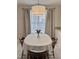 Bright breakfast nook featuring a round dining table with seating and natural light from the window at 1613 Bulon Dr, Cary, NC 27518