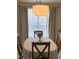 Inviting dining room with modern lighting fixture and a bright window view, perfect for Gathering meals at 1613 Bulon Dr, Cary, NC 27518