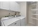 Functional laundry room with washer, dryer, and shelving for storage at 1613 Bulon Dr, Cary, NC 27518
