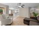 Inviting living room with a ceiling fan, tile flooring, and easy access to the kitchen and outdoor space at 1613 Bulon Dr, Cary, NC 27518