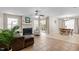 Open-concept living room with fireplace, tile floors and sliding door to outdoor area at 1613 Bulon Dr, Cary, NC 27518