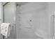 Bright white tiled shower with safety bars and a sleek, modern design at 1613 Bulon Dr, Cary, NC 27518