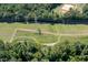 Aerial view of power lines crossing over a green and wooded area with a creek running through the landscape at 195 Falcon Ln, Rougemont, NC 27572