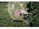 Overhead shot highlights the house, hot tub, and surrounding trees, illustrating privacy and outdoor amenities at 195 Falcon Ln, Rougemont, NC 27572