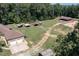 Aerial view showcases the property's layout, including the home, pastures, outbuildings, and equestrian facilities at 195 Falcon Ln, Rougemont, NC 27572