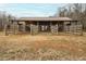 View of horse property featuring the horse barn, fence panels, and an open field at 195 Falcon Ln, Rougemont, NC 27572