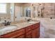 Granite counters accent dual sinks in the primary bathroom, featuring a tiled shower with glass surround at 195 Falcon Ln, Rougemont, NC 27572