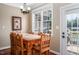 This eat-in kitchen features a breakfast nook, wooden chairs, and a door that leads to an outdoor deck at 195 Falcon Ln, Rougemont, NC 27572