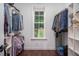 A custom closet is spacious, with storage shelves and wooden floors, with a window showing the outdoors at 195 Falcon Ln, Rougemont, NC 27572