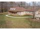 Exterior side view of the house featuring a front porch with columns, grass, and landscaping at 195 Falcon Ln, Rougemont, NC 27572