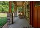 Cozy front porch featuring stone columns, wood accents, and rocking chairs, perfect for relaxation at 195 Falcon Ln, Rougemont, NC 27572