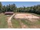 Aerial view showcasing the horse arena, barn, and surrounding pastures of the equestrian property at 195 Falcon Ln, Rougemont, NC 27572