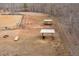 Equestrian property featuring a horse arena, paddocks, and shelters for livestock with wooded surroundings at 195 Falcon Ln, Rougemont, NC 27572